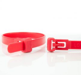 Een hersluitbare rode kunststof kabelbinder, naast een uitvergrote sluiting van een andere rode hersluitbare kabelbinder.